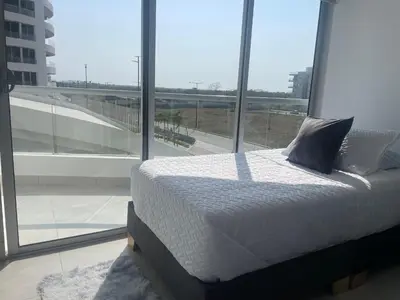a bed in a room with a large window at Moderno Apartamento en Cartagena in Cartagena de Indias