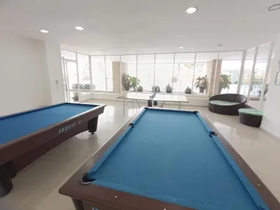 a pool table in a large room with windows at Apartamento en Los Morros - Cartagena de Indias in Cartagena de Indias