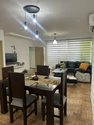 a living room with a table and a couch at Casa de campo con piscina, aire acondicionado, estacionamiento privado con BBQ in Barranquilla