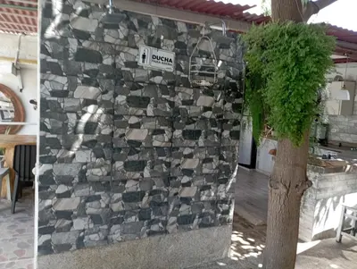 a stone wall with a street sign on it at Jardín de Díos in Santa Marta