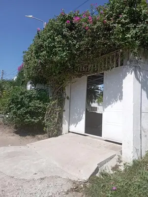 a white building with flowers on top of it at Jardín de Díos in Santa Marta