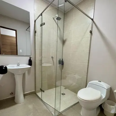 a bathroom with a shower and a toilet and a sink at Casa Rio in Mangue