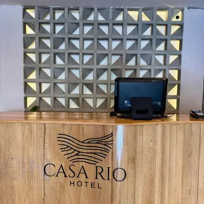 a desk with a laptop on top of a casa rio hotel at Casa Rio in Mangue