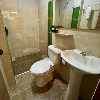 a bathroom with a toilet and a sink and a shower at Casa Rio in Mangue