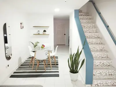 a dining room with a table and a staircase at Apto Centro Historico Quero in Cartagena de Indias