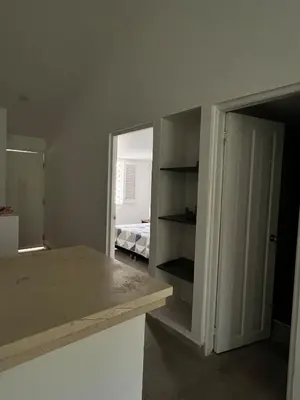 a kitchen with a counter and an open door at Apartamento en ciudad amurallada centro histórico Cartagena de Indias, Colombia in Cartagena de Indias