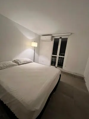 a white bed in a room with a window at Apartamento en ciudad amurallada centro histórico Cartagena de Indias, Colombia in Cartagena de Indias