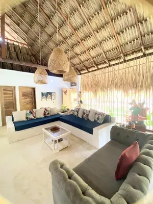 a living room with a couch and a table at Habitación 6 personas in Moñitos