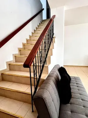 a couch sitting in front of a staircase at Casa Naty Crespo in Cartagena de Indias