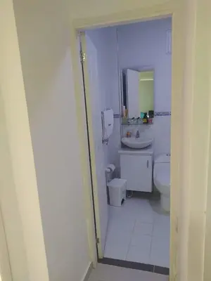 a white bathroom with a sink and a toilet at Chalet Ledymar in Cartagena de Indias