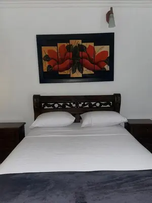 a bedroom with a white bed with a picture on the wall at Hotel Cartagena Comfort in Cartagena de Indias