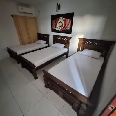 a room with three beds in a room at Hotel Cartagena Comfort in Cartagena de Indias