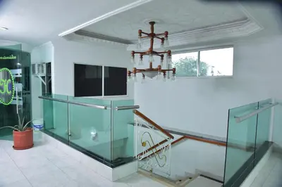 a room with a staircase with a chandelier at Hotel Cartagena Comfort in Cartagena de Indias