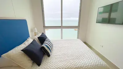 a bedroom with a bed with two pillows on it at Magico Apartamento Frente al Mar 4 Habitaciones BM83 in Coveñas