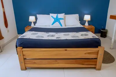 a bedroom with a bed with a blue wall at Loft with view 7 rooms in Cartagena de Indias