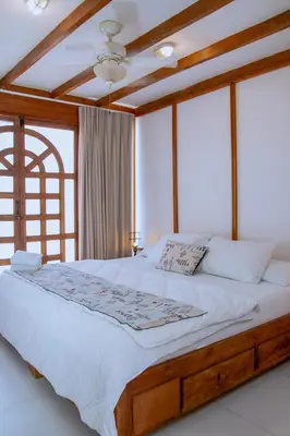 a bedroom with a large bed with white sheets at Loft with view 7 rooms in Cartagena de Indias