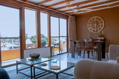 a living room with a table and a clock on the wall at Loft with view 7 rooms in Cartagena de Indias