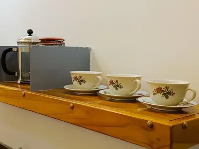 three coffee cups and saucers on a wooden table at Acogedores Apartaestudios en Getsemaní in Cartagena de Indias