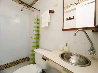 a bathroom with a toilet and a sink at Acogedores Apartaestudios en Getsemaní in Cartagena de Indias