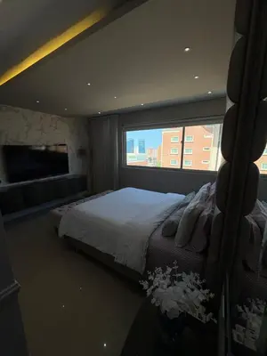 a bedroom with a bed and a large window at Apto moderno frente CC Buenavista, lujo y vistas in Barranquilla
