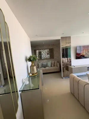 a living room with a couch and a table at Apto moderno frente CC Buenavista, lujo y vistas in Barranquilla