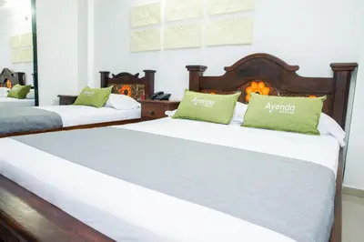 a bedroom with two beds and a fireplace at Ayenda 1315 Candiac in Barranquilla