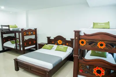 a room with three bunk beds with flowers on them at Ayenda 1315 Candiac in Barranquilla