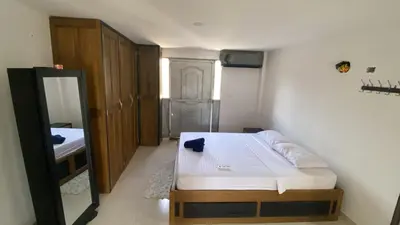 a small bedroom with a bed and a mirror at Casa Finca la Parcela in San Onofre