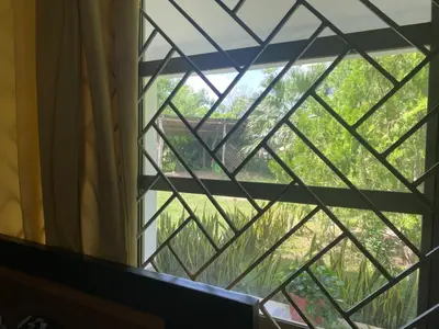 a window with a view of a field through it at Casa Finca la Parcela in San Onofre