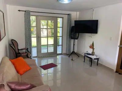 a living room with a couch and a flat screen tv at Casa Finca la Parcela in San Onofre