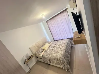 a small bedroom with a bed and a television at MY lOVE BARRANQUILLA 1 in Barranquilla