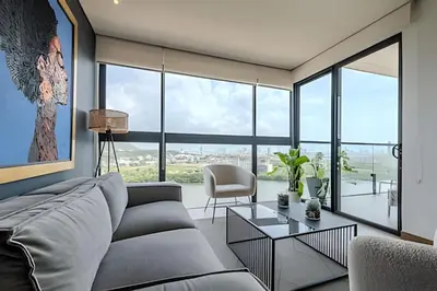 a living room with a couch and a table at NEW Panoramic view, Infinite Pool/Historic Center in Cartagena de Indias