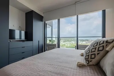 a bedroom with a large bed with a large window at NEW Panoramic view, Infinite Pool/Historic Center in Cartagena de Indias