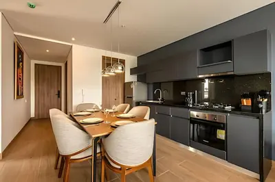 a dining room with a table and chairs in a kitchen at NEW Panoramic view, Infinite Pool/Historic Center in Cartagena de Indias