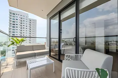 a living room with a couch and a table at NEW Panoramic view, Infinite Pool/Historic Center in Cartagena de Indias