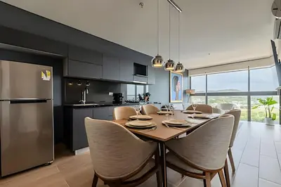 a kitchen and dining room with a table and chairs at NEW Panoramic view, Infinite Pool/Historic Center in Cartagena de Indias