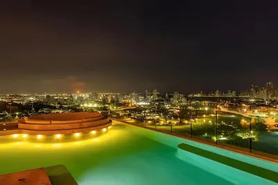 a pool with a view of a city at night at NEW Panoramic view, Infinite Pool/Historic Center in Cartagena de Indias