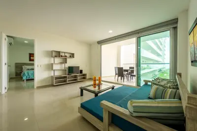 a living room with a bed and a living room with a view at Morros Epic 216 in Cartagena de Indias
