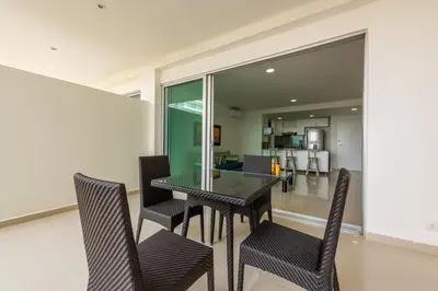 a dining room with a glass table and chairs at Morros Epic 216 in Cartagena de Indias