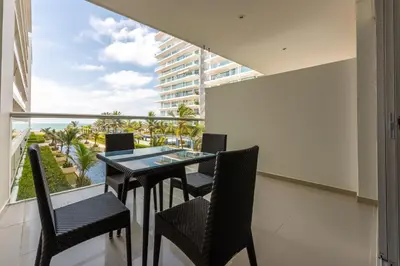 a balcony with a table and chairs and a large window at Morros Epic 216 in Cartagena de Indias