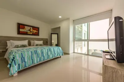 a bedroom with a bed and a flat screen tv at Morros Epic 216 in Cartagena de Indias