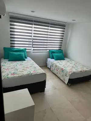 two beds sitting next to each other in a room at Lujoso Penthouse Duplex 403m2 con Terraza Privada y vista al mar in Cartagena de Indias