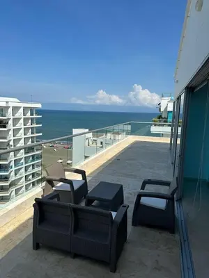 a balcony with chairs and a view of the ocean at Lujoso Penthouse Duplex 403m2 con Terraza Privada y vista al mar in Cartagena de Indias