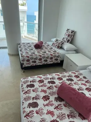 a living room with two beds and a couch at Lujoso Penthouse Duplex 403m2 con Terraza Privada y vista al mar in Cartagena de Indias