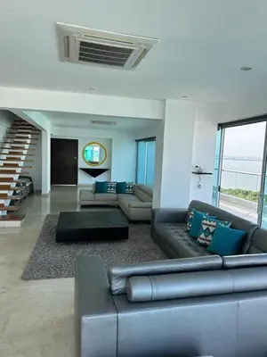 a large living room with a couch and a table at Lujoso Penthouse Duplex 403m2 con Terraza Privada y vista al mar in Cartagena de Indias
