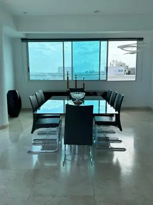 a dining room with a glass table and chairs at Lujoso Penthouse Duplex 403m2 con Terraza Privada y vista al mar in Cartagena de Indias