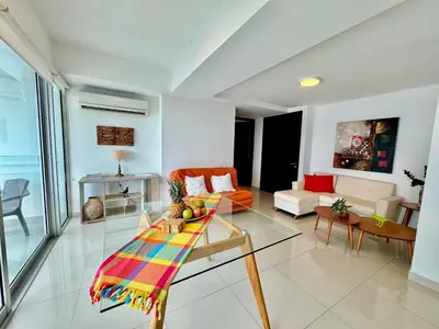 a living room with a glass table and a couch at Apartamento 1 dormitorio Morros. Vista Mar y Salida Playa in Cartagena de Indias