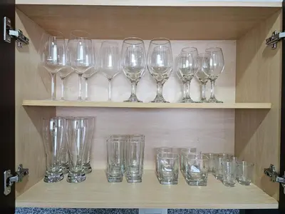 a bunch of glasses sitting on a shelf at Apartamento en el Hotel Estelar in Barranquilla