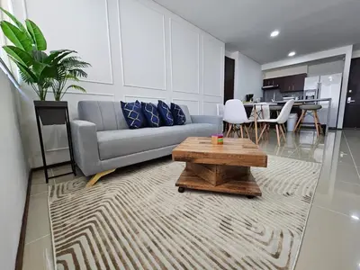 a living room with a couch and a coffee table at Apartamento en el Hotel Estelar in Barranquilla