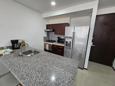 a kitchen with a refrigerator and a counter top at Apartamento en el Hotel Estelar in Barranquilla